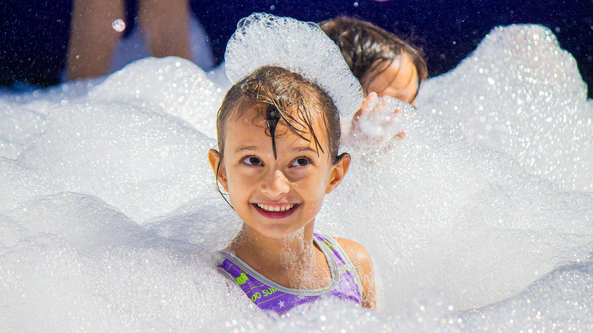 kids playing with non-toxic foam at a foam cannon party in McKinney